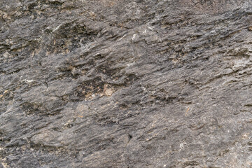 Grungy cracked stone texture from natural rock retro style. Weathered ancient wall background