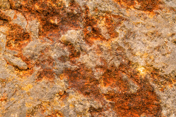 Naklejka premium Grungy bright stone close up, rusty stone wall corrosion texture