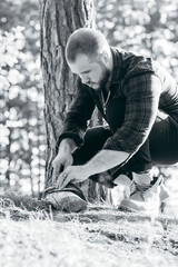 A man with a knife cuts fish in forest