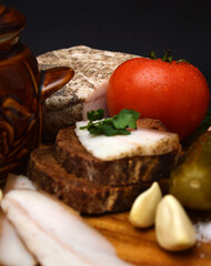 Ukrainian national cuisine: borscht in faience, vegetables, bread and bacon.