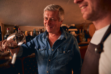 Contented sommelier looking at the amazing color of beverage