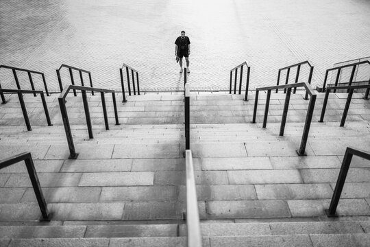 A man stands in the center of the stairs.