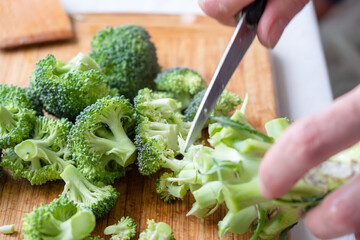 Fresh green broccoli on a wooden cutting board. Macro photo green fresh vegetable broccoli.