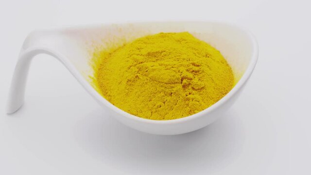 Turmeric powder. Condiment or dietary supplement. Rotating table, seamless loop.