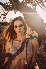 Beautiful woman posing on nature with eagle
