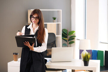 american woman working laptop. Business woman busy working on laptop computer in the office.