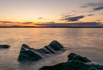 Sunset over lake Näsijärvi with rocks, Tampere Finland