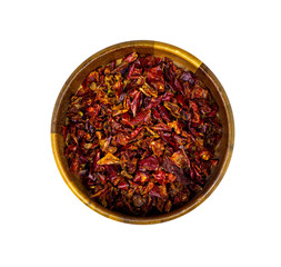 Top view of dry red chili pepper slices in a round wooden bowl isolated on white background.