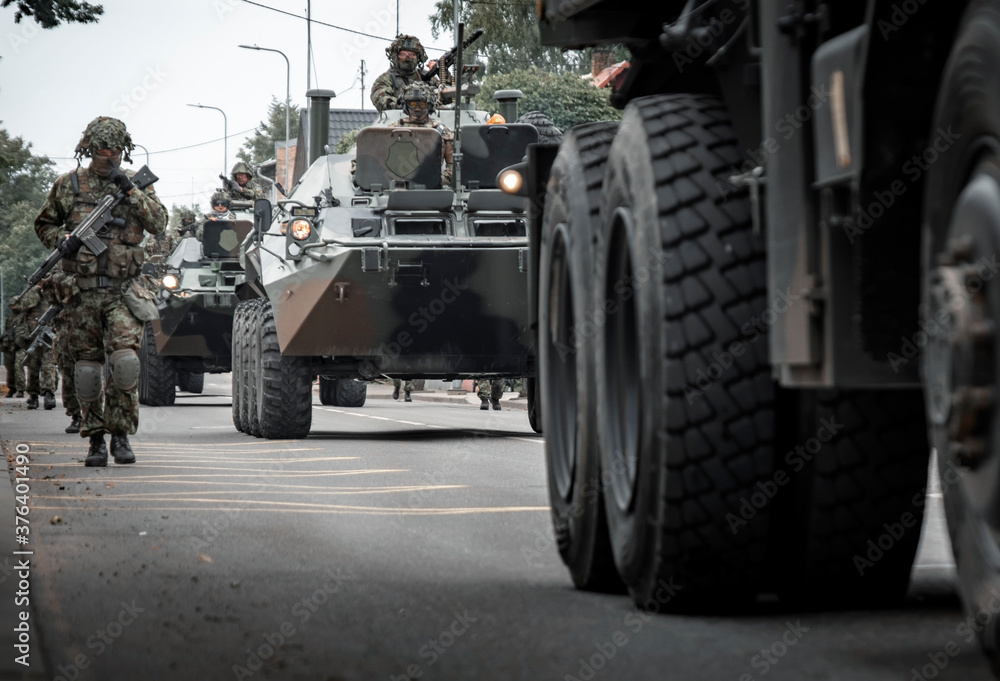 Wall mural soldiers and armored vehicles enter the city