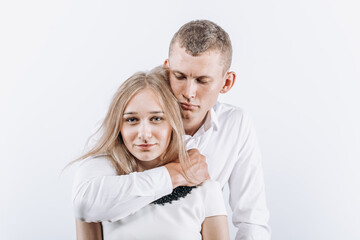 Fear abuse or domestic violence concept. The man hugs the woman menacingly