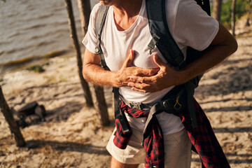 Man complaining on pain in chest while hiking
