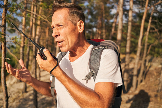 Man using walkie talkie while hiking in wood