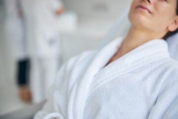 Relaxed female patient dressed in a bathrobe