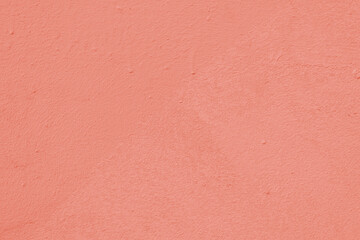 Fototapeta premium Peach wall of the building. Rough plaster surface. Abstract background.