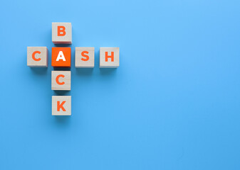 Wooden cubes with Cash Back Crossword on blue background.