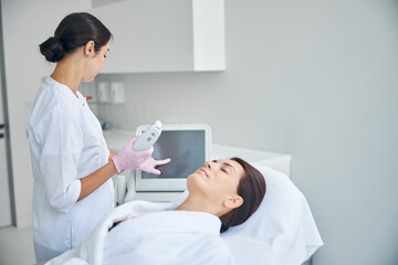 Dermatologist preparing a patient for an ultrasound treatment