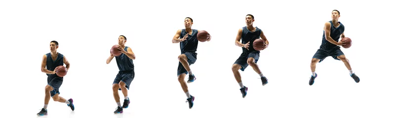 Foto auf Acrylglas High flight. Young basketball player of team training in action, motion in jump of step-to-step goal isolated on white background. Concept of sport, movement, energy and dynamic, healthy lifestyle. © master1305