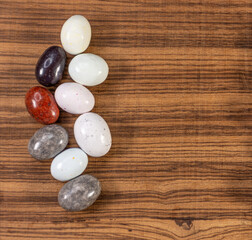 Colorful chocolate eggs on exotic natural wood background