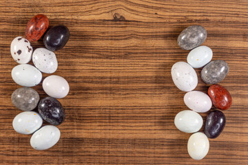 Colorful chocolate eggs on exotic natural wood background