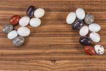Colorful chocolate eggs on exotic natural wood background
