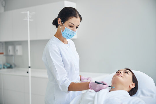 Doctor cauterizing a nevus using electric current