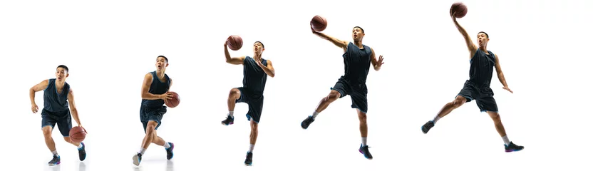 Gordijnen Winner. Young basketball player of team training in action, motion in jump of step-to-step goal isolated on white background. Concept of sport, movement, energy and dynamic, healthy lifestyle. © master1305