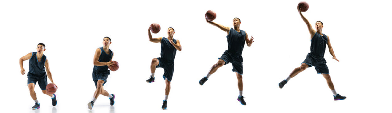 Winner. Young basketball player of team training in action, motion in jump of step-to-step goal isolated on white background. Concept of sport, movement, energy and dynamic, healthy lifestyle.