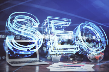 Multi exposure of table with computer and seo drawing hologram. Search optimization concept.