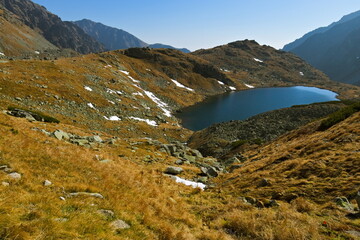 Mountain lake in autumn with first snow and clear sky
