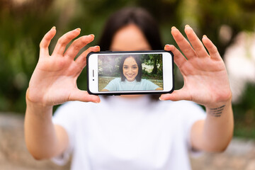 Young caucasian woman making a selfie at outdoors