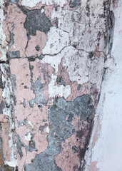 Background texture wall with peeling old paint. Old wooden background with remains of pieces of scraps of old paint on wood. Texture of an old tree, board with paint, vintage background peeling paint
