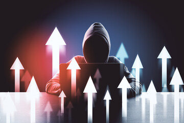 Hacker in hoodie at desktop using laptop with abstract digital arrow interface