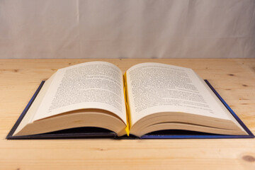 Obraz premium Open book on a natural wooden background