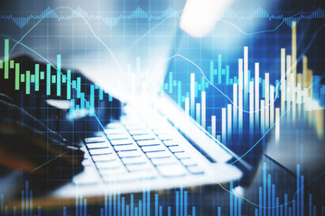 Businessman hand using laptop with business chart.