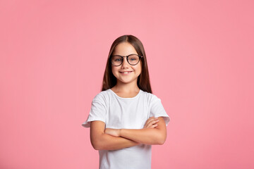 Fototapeta premium Smart kid. Cheerful little child in glasses with crossed arms
