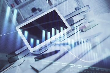Fototapeta premium Forex graph hologram on table with computer background. Multi exposure. Concept of financial markets.