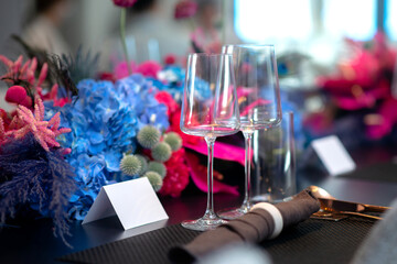 empty wine glasses set up on vibrant flower decor table