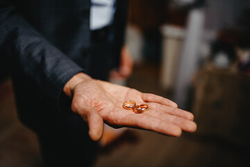 wedding rings on hands of groom