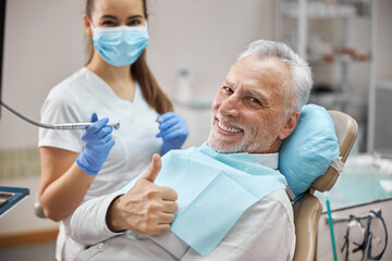 Positive aging patient feeling well visiting a dentist