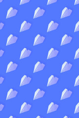 Pattern from white paper airplanes on a blue background. Creative concept of travel, flights..