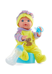 Plastic baby doll sits in baby clothes on a baby pot with a baby pacifier in its hand, isolated on a white background.