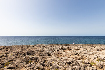 Fototapeta na wymiar Sea holiday and vacation. Beach and rock on mediterranean island