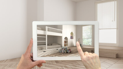 Augmented reality concept. Hand holding tablet with AR application used to simulate furniture and design products in empty interior with parquet floor, modern children bedroom