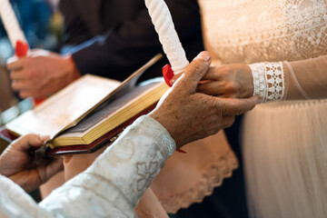 bride and groom holding hands in church