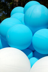 Air balloons background, big bunch of helium balloons, happy birthday, surprise for holiday, decoration. Festive background of blue and white air balloons of different sizes on sky background.