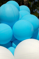 Air balloons background, big bunch of helium balloons, happy birthday, surprise for holiday, decoration. Festive background of blue and white air balloons of different sizes on sky background.
