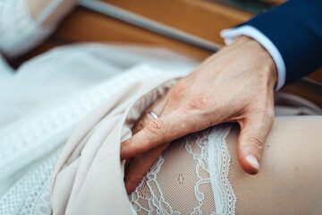 groom touches garter
