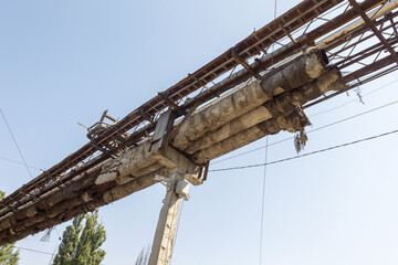 Overground heat pipes. Pipeline above ground, conducting heat for heating city. City aerial overground heating main in metal thermal insulation in residential city quarter. Open laying mains on poles