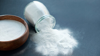 Glass bowl of baking soda. Spoonful of bicarbonate.