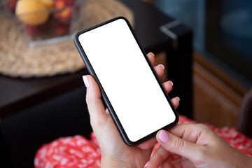 female hand in red dress holding phone with isolated screen